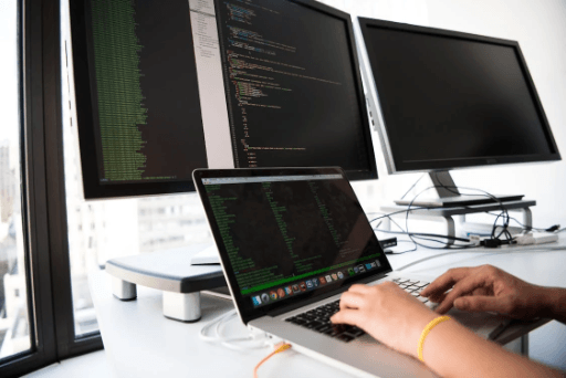 Student learning machine learning with code and data visualisation on a laptop